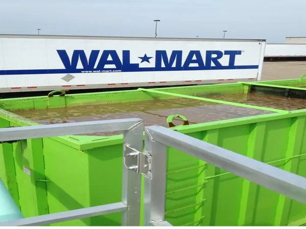 Green containers near Walmart truck